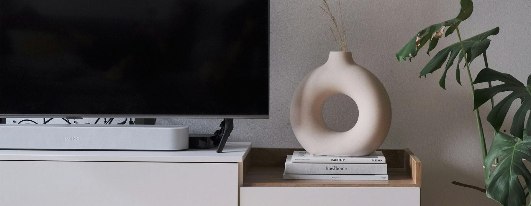 a tv on a stand with decor