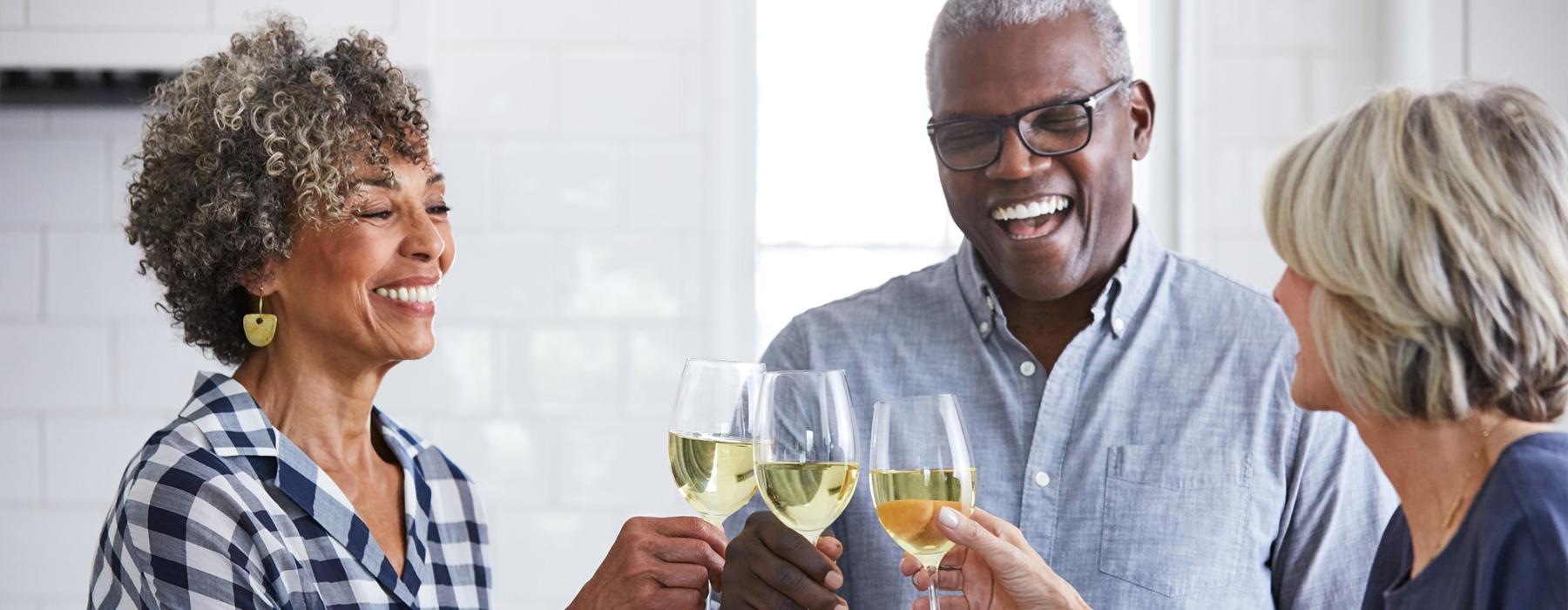 a few people toasting wine glasses