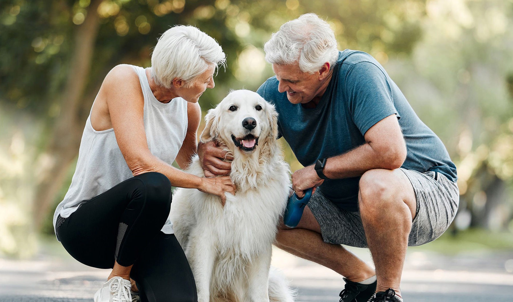 a man and woman petting a dog
